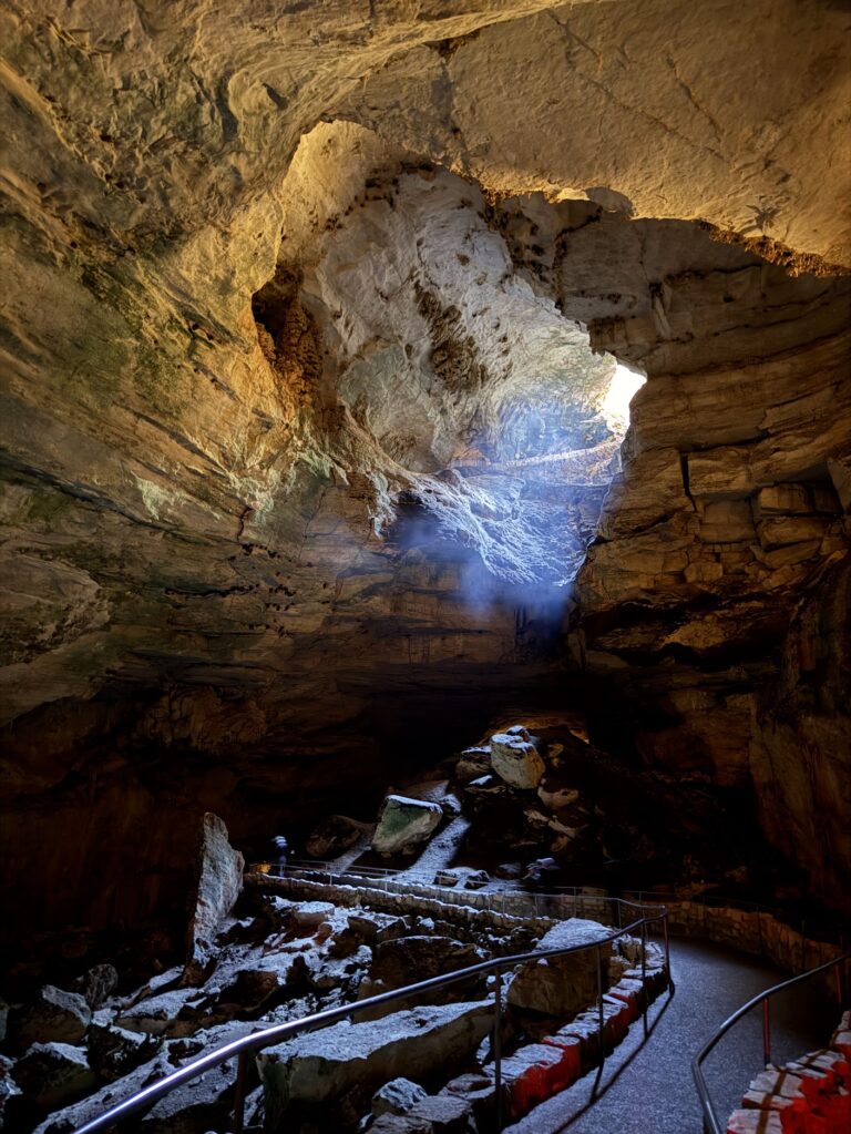 Last bit of natural light fades away as you get deeper but the caverns is lit with artificial light.