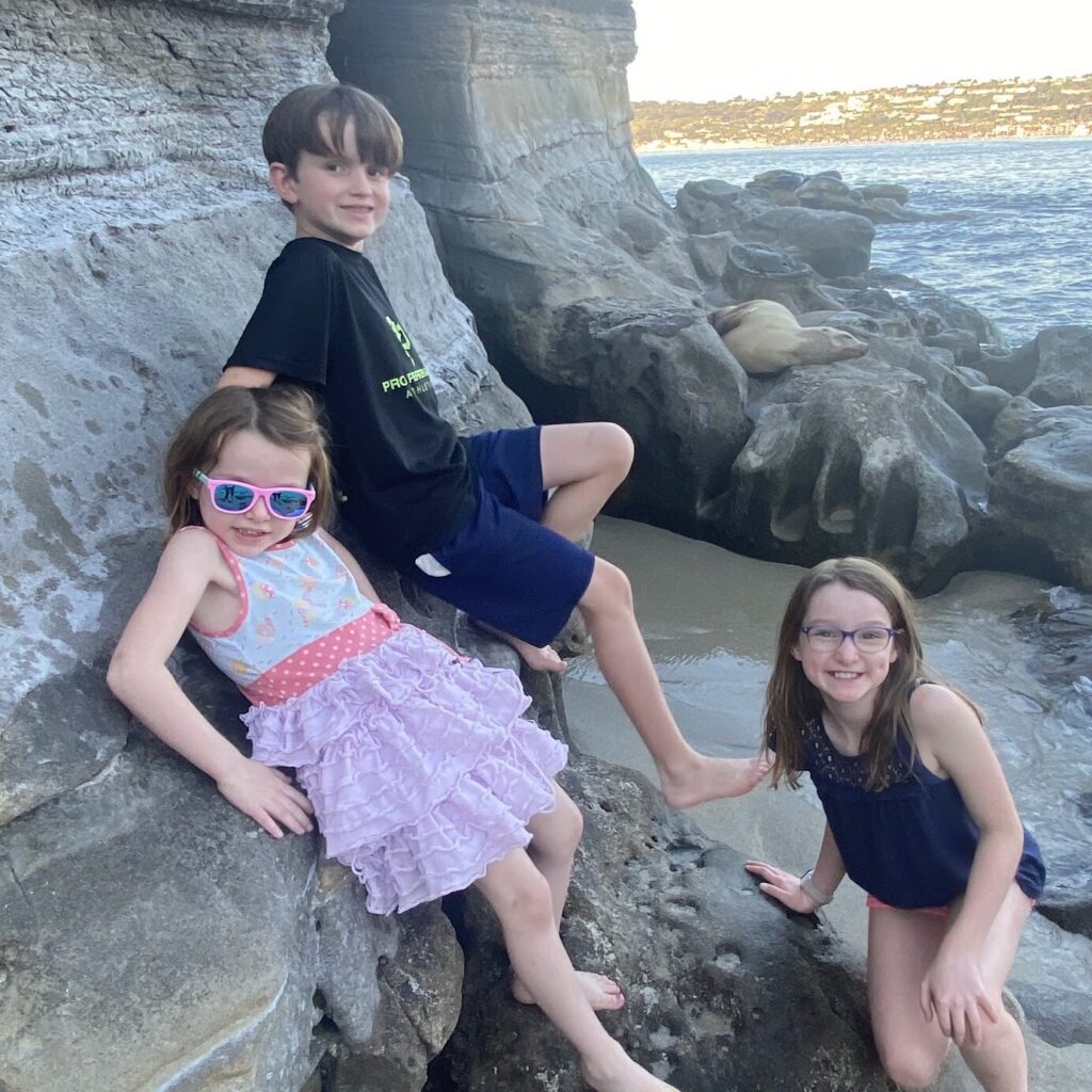 Kids with sea lions in La Jolla Cove, California